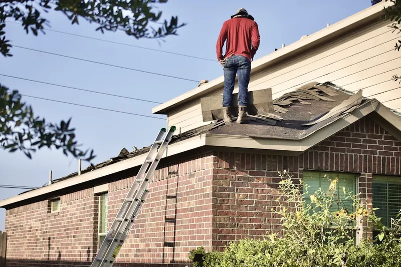 Professional roofer working on a residential roof in Paseo Pointe